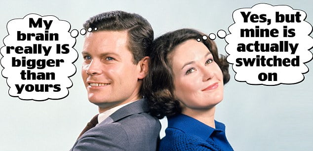1960s SMILING MAN AND WOMAN STANDING BACK TO BACK WITH ARMS FOLDED 